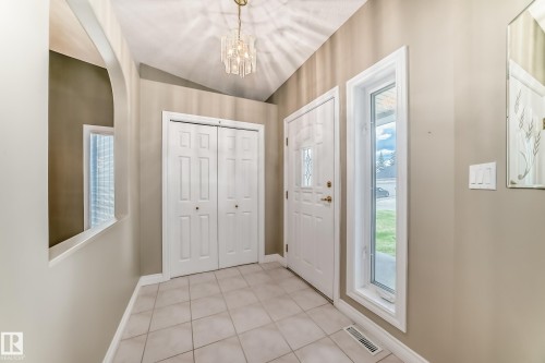Tiled entryway featuring a vaulted ceiling and a decorative chandelier - 29 929 Picard Drive, Edmonton, AB - Indoor Photo Showing Other Room