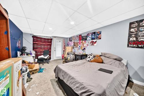 Carpeted room featuring a white drop ceiling with recessed lighting - 199 Westridge Road, Edmonton, AB 