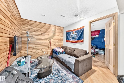 Recessed lighting illuminates wood-finish plank accent wall - 199 Westridge Road, Edmonton, AB 