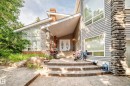 Contemporary exterior featuring horizontal siding and stacked stone accents - 199 Westridge Road, Edmonton, AB 
