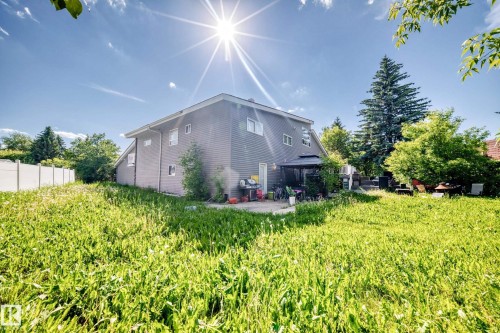 Expansive rear yard featuring green space, mature trees, and a private patio with an attached gazebo - 199 Westridge Road, Edmonton, AB 