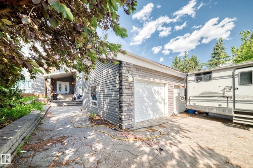 Detached garage with two white garage doors and stone veneer accents - 199 Westridge Road, Edmonton, AB 