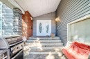Property entrance featuring double doors with oval glass inserts, stone column detailing, and brick accents - 199 Westridge Road, Edmonton, AB 