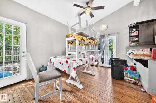 Open-concept space featuring wood-finish flooring, vaulted ceiling, and a ceiling fan - 199 Westridge Road, Edmonton, AB 