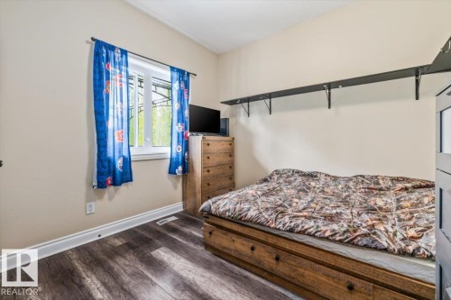 Interior room featuring wood-finish flooring, a white window frame, and neutral wall paint - #6 2406 Twp Road 540, Rural Lac Ste. Anne County, AB - Indoor Photo Showing Bedroom