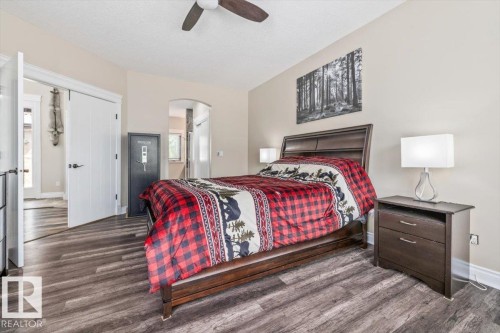 Bedroom featuring wood-finish flooring, neutral wall tones, and a ceiling fan - #6 2406 Twp Road 540, Rural Lac Ste. Anne County, AB - Indoor Photo Showing Bedroom