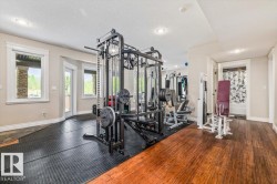 Dedicated fitness space with rubber flooring and wood-finish flooring - 