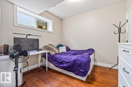 Lower-level room with a horizontal window and wood-finish flooring - #6 2406 Twp Road 540, Rural Lac Ste. Anne County, AB - Indoor Photo Showing Bedroom