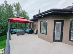 Spacious concrete balcony featuring a black metal railing and direct exterior access - 