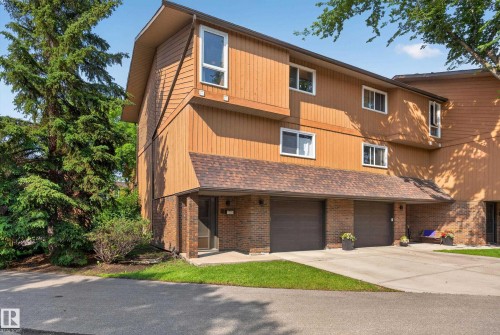 Multi-level brown-sided exterior with a shingled roofline - 12062 157 Avenue, Edmonton, AB 