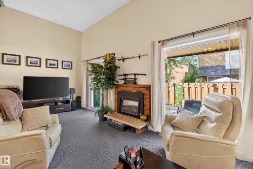 Living area with vaulted ceiling and gray carpeting - 12062 157 Avenue, Edmonton, AB 