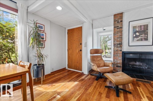 Entry area featuring a solid wood door and wood-finish flooring - 11603 70 Street Nw, Edmonton, AB 