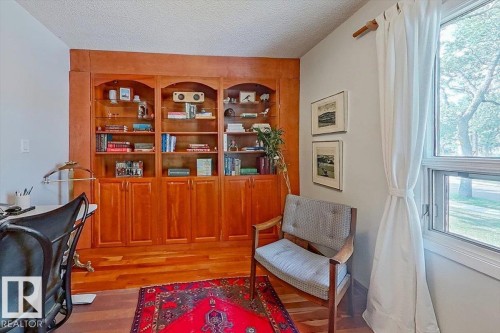 Built-in wood cabinetry with arched open shelving and lower storage - 11603 70 Street Nw, Edmonton, AB 