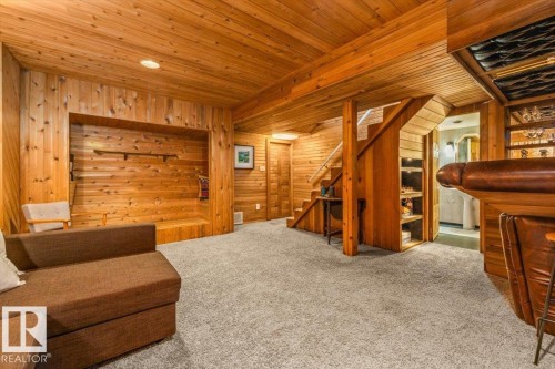 Finished basement featuring extensive wood paneling, wood-plank ceiling, recessed lighting, and light-toned carpeting - 11603 70 Street Nw, Edmonton, AB 
