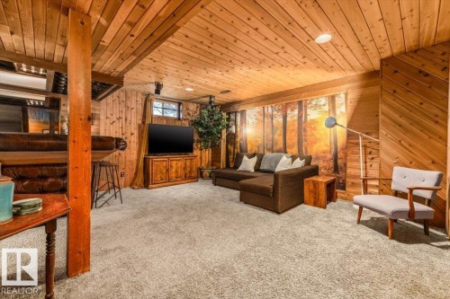 Recreation room featuring wood-paneled walls and ceiling, recessed lighting, and soft carpet flooring - 11603 70 Street Nw, Edmonton, AB 