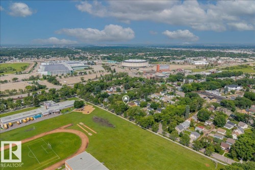 Aerial perspective showcasing a residential area with extensive green spaces and urban amenities - 11603 70 Street Nw, Edmonton, AB 