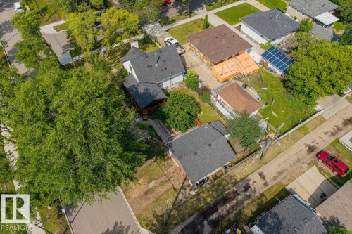 Aerial view showcasing a residential property with a dark shingle roof and a separate garage structure - 11603 70 Street Nw, Edmonton, AB 