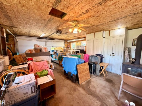 Inside garage with plywood walls and garage door opener - 5004 50 Avenue, Evansburg, AB 