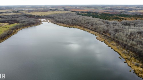 Expansive body of water bordered by varied deciduous and coniferous tree lines - Rge Rd 62, Rural Barrhead County, AB 