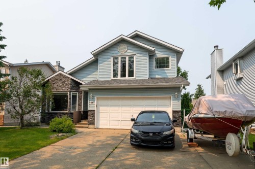 Two-story residence featuring light blue siding and dark stone facade accents - 14 Durand Place, St. Albert, AB 