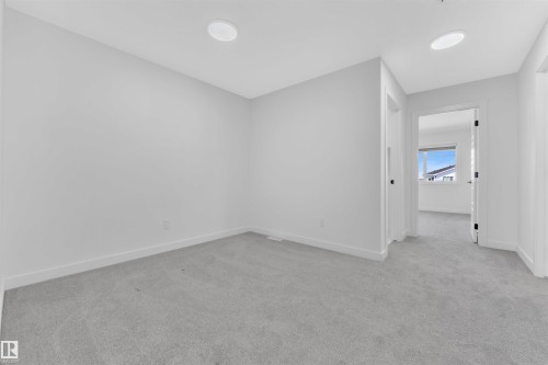 Carpeted room featuring recessed lighting, white walls, and white baseboards - 523 Kleins Court, Leduc, AB - Indoor Photo Showing Other Room