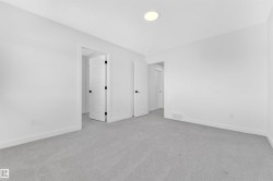Neutral gray carpeting complements bright white walls and trim - 