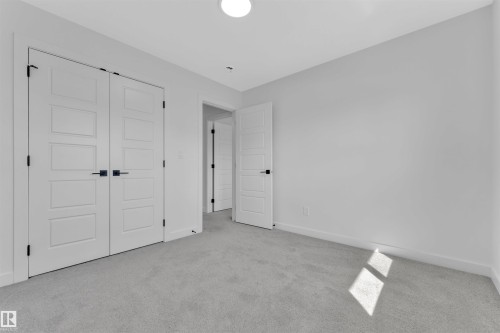 Spacious room featuring light gray carpeting and white walls - 523 Kleins Court, Leduc, AB - Indoor Photo Showing Other Room