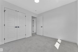 Spacious room featuring light gray carpeting and white walls - 
