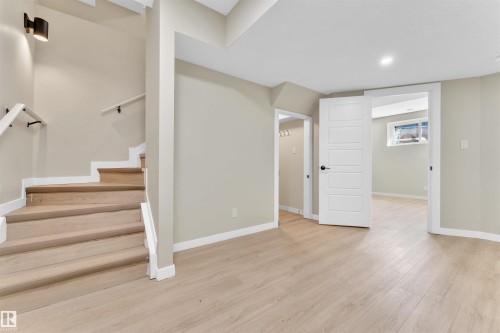 Light wood-finish flooring extends throughout this finished space, complemented by neutral wall tones - 523 Kleins Court, Leduc, AB - Indoor Photo Showing Other Room