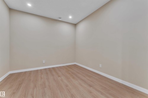 Room featuring light-toned walls, wood-finish flooring, recessed ceiling lighting, and white baseboards - 523 Kleins Court, Leduc, AB - Indoor Photo Showing Other Room