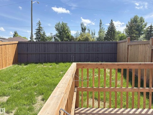 Private backyard featuring a natural wood deck railing and mixed privacy fencing with both natural wood and dark-stained panels - 523 Kleins Court, Leduc, AB - Outdoor With Deck Patio Veranda
