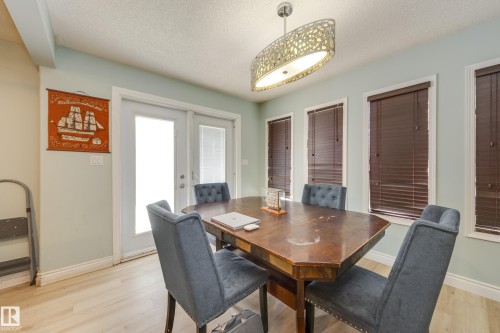 Dining area featuring pale blue walls and light wood-finish flooring - 17328 106 Street, Edmonton, AB 