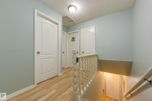 Upper level hallway featuring light wood-finish flooring - 17328 106 Street, Edmonton, AB 