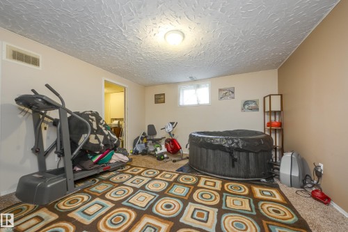 Carpeted room with a textured white ceiling and recessed window - 17328 106 Street, Edmonton, AB 