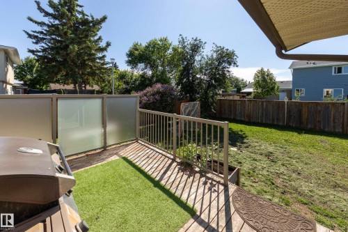 Backyard deck featuring wood planking and artificial turf - 17328 106 Street, Edmonton, AB 