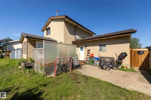 Stucco exterior featuring a two-story design with an attached single-story extension - 17328 106 Street, Edmonton, AB 