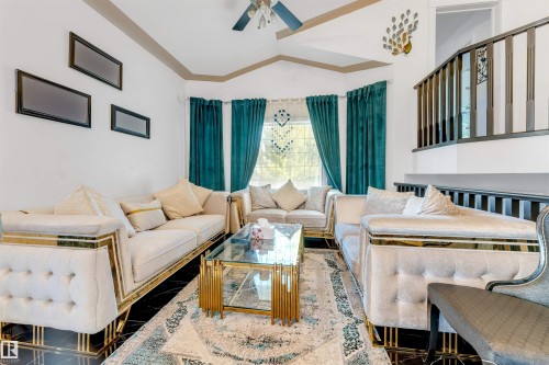 Living area featuring dark tile flooring and a multi-level ceiling - 7920 7 Avenue, Edmonton, AB 