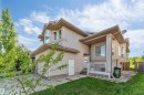 Beige siding exterior with multiple gables and a covered front porch - 7920 7 Avenue, Edmonton, AB 