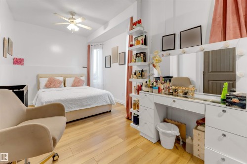 Bedroom featuring wood-finish flooring and a ceiling fan - 7920 7 Avenue, Edmonton, AB 