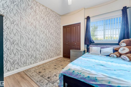Accent wall featuring a contemporary graphic design with a subtle texture - 7920 7 Avenue, Edmonton, AB 