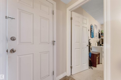 Six-panel interior doors with chrome hardware, neutral wall color, and trim detailing - 7920 7 Avenue, Edmonton, AB 