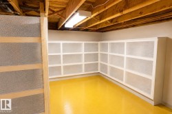 Built-in corner shelving with white framing and mesh panels, set against a painted wall with a vibrant floor finish - 