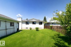 Expansive green lawn with a wooden picket fence perimeter - 