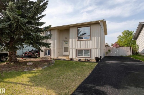 Split-level residence featuring light-colored vertical siding and contrasting trim - 4620 37A Avenue, Edmonton, AB - Outdoor