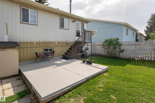 Ground-level patio area featuring a concrete surface and direct access to a grassy yard - 4620 37A Avenue, Edmonton, AB - Outdoor With Exterior