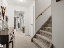 Carpeted staircase with a wood-finish handrail - 