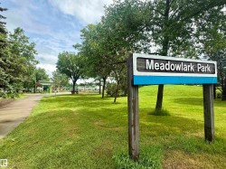Meadowlark Park sign with a wooden frame and white and blue accents - 