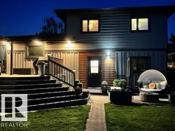 Multi-level exterior deck with dark wood-finish stairs and integrated lighting - 
