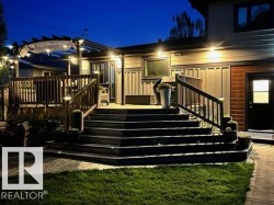 Multi-level wood deck with integrated lighting, glass-paneled double doors, and a pergola structure - 