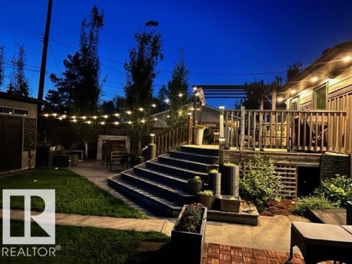 Multi-level deck with wood railing, leading to a stone patio - 8822 161 Street, Edmonton, AB 